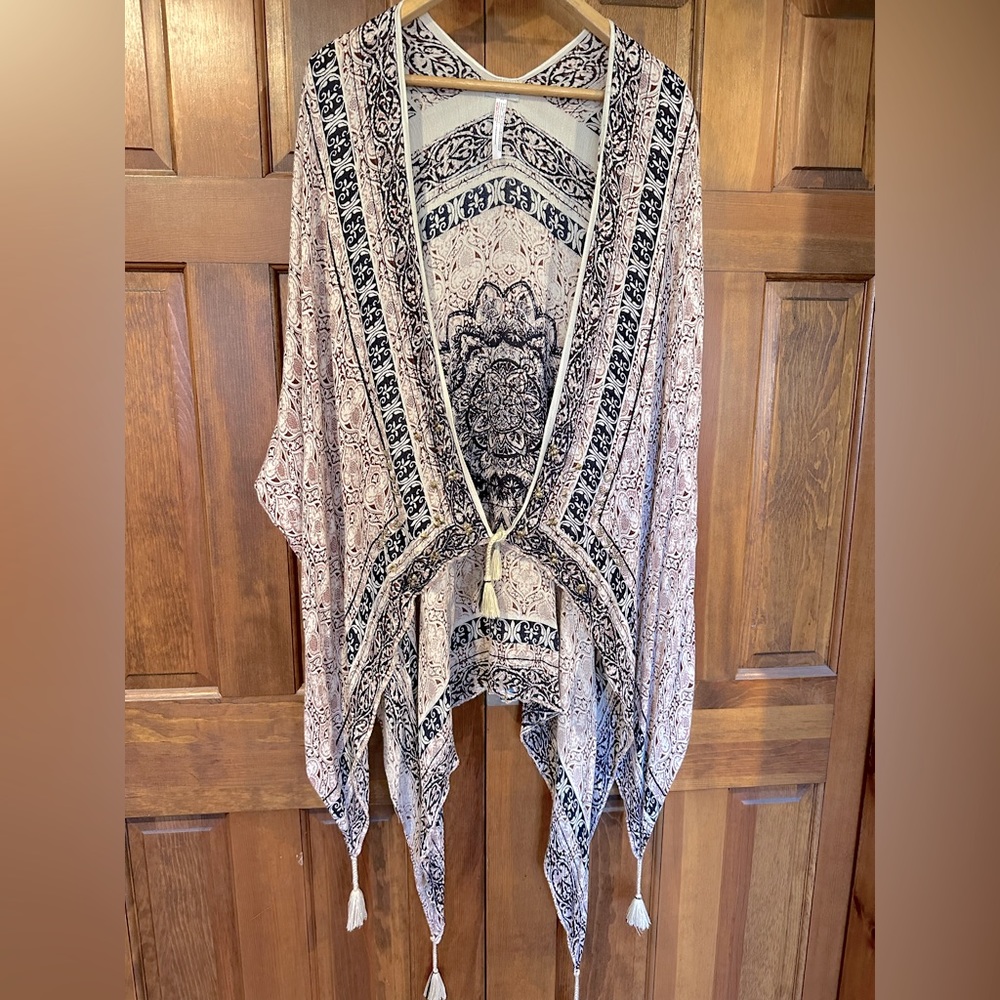 Ecoté sheer poncho with intricate patterns, beading and tassels